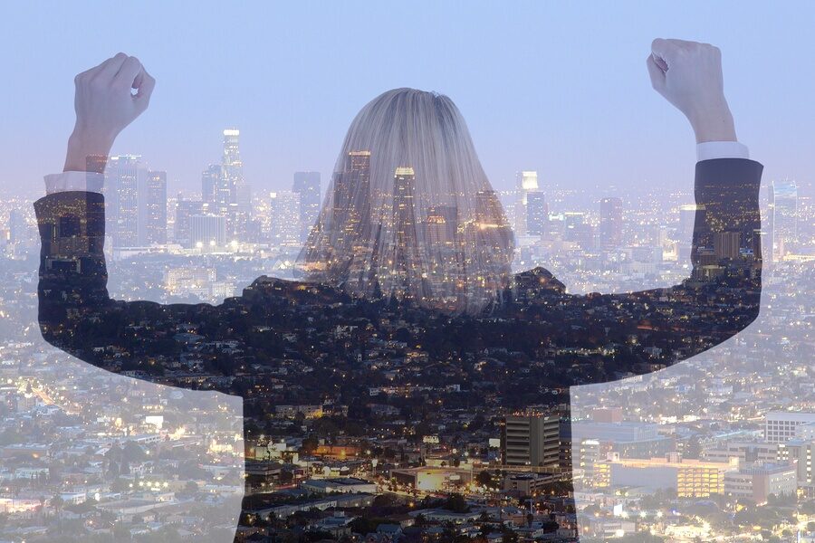 woman holding up hands triumphantly