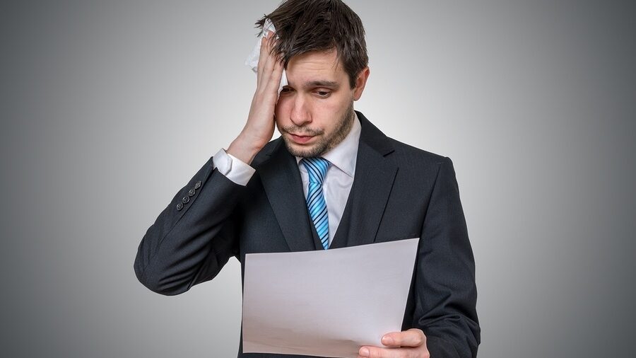 man confused with paper