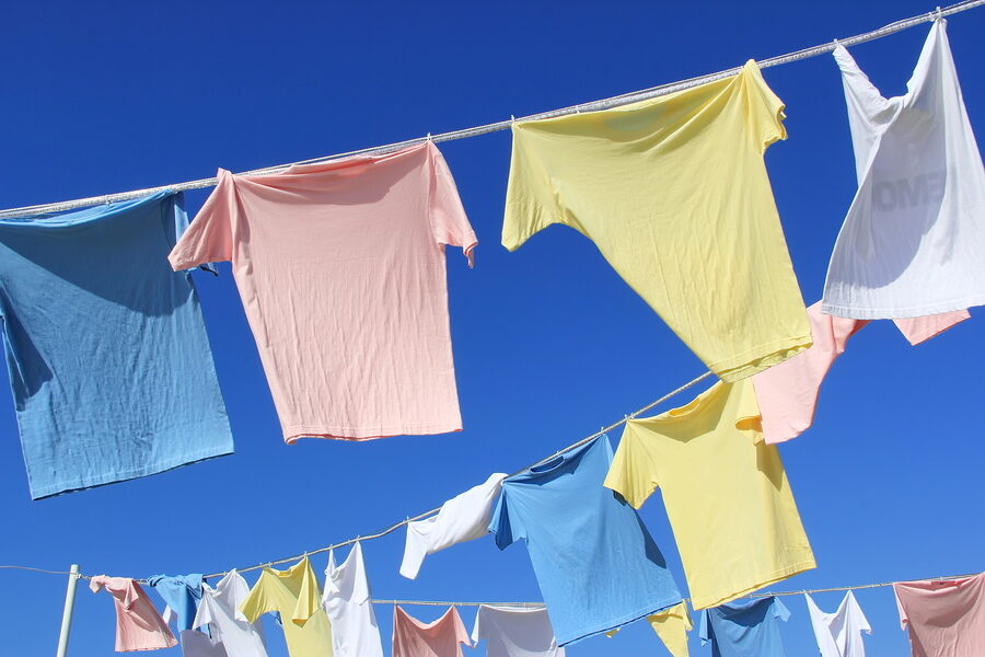 T-shirts Hanging On A Clothesline In Front Of Blue Sky